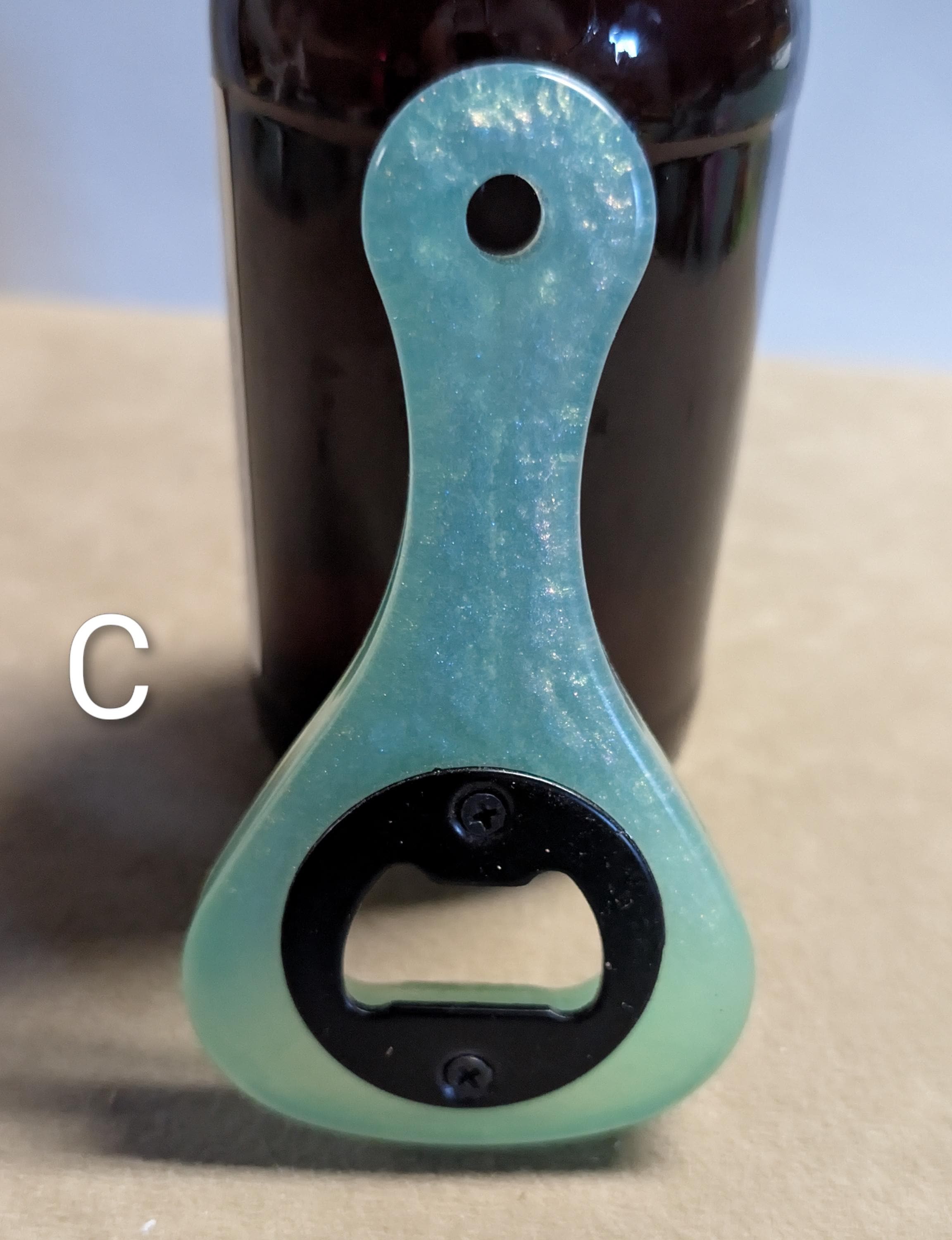 Paddle shaped bottle opener. Orange in color. Many other colors also available