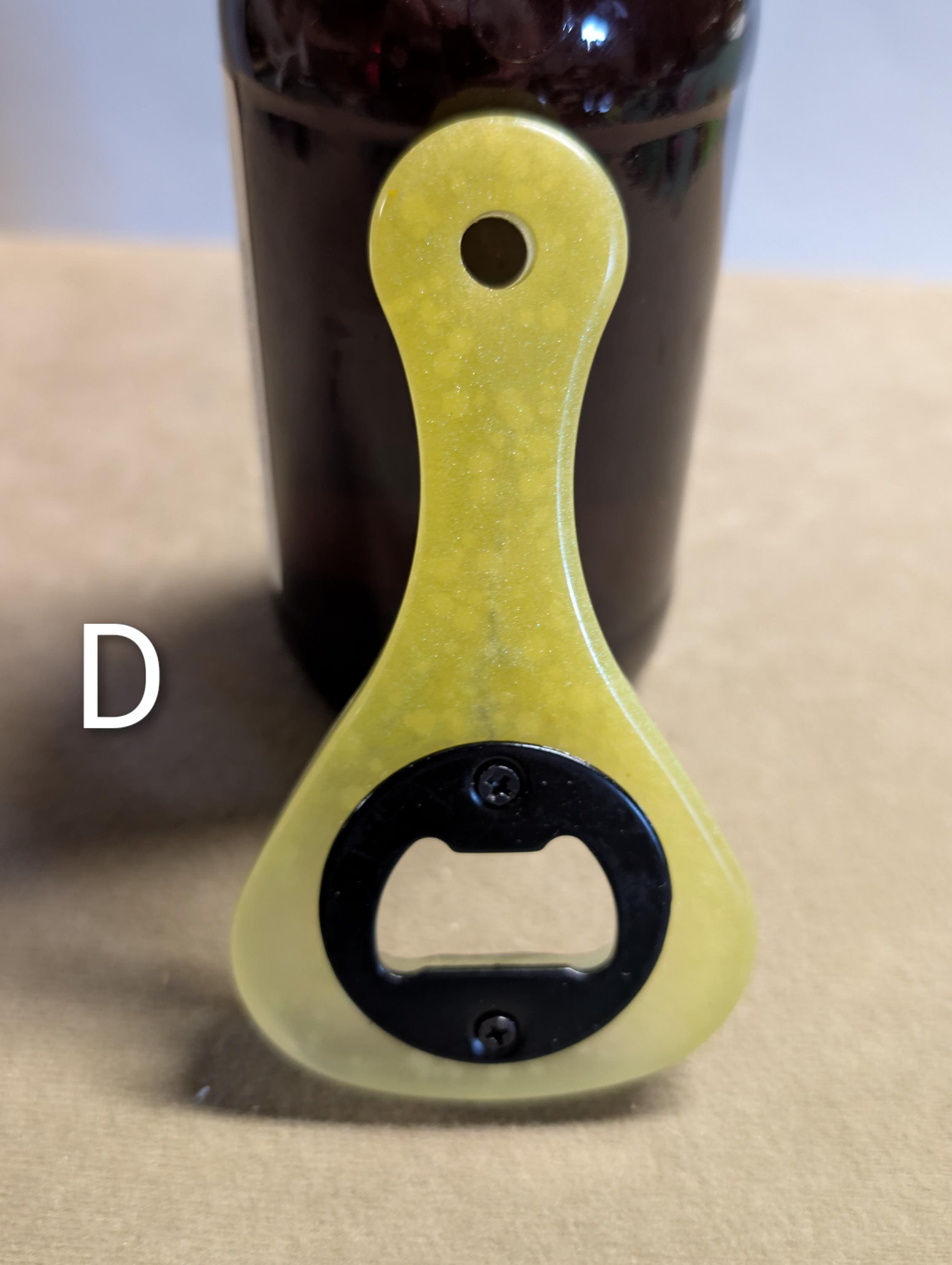 Paddle shaped bottle opener. Orange in color. Many other colors also available