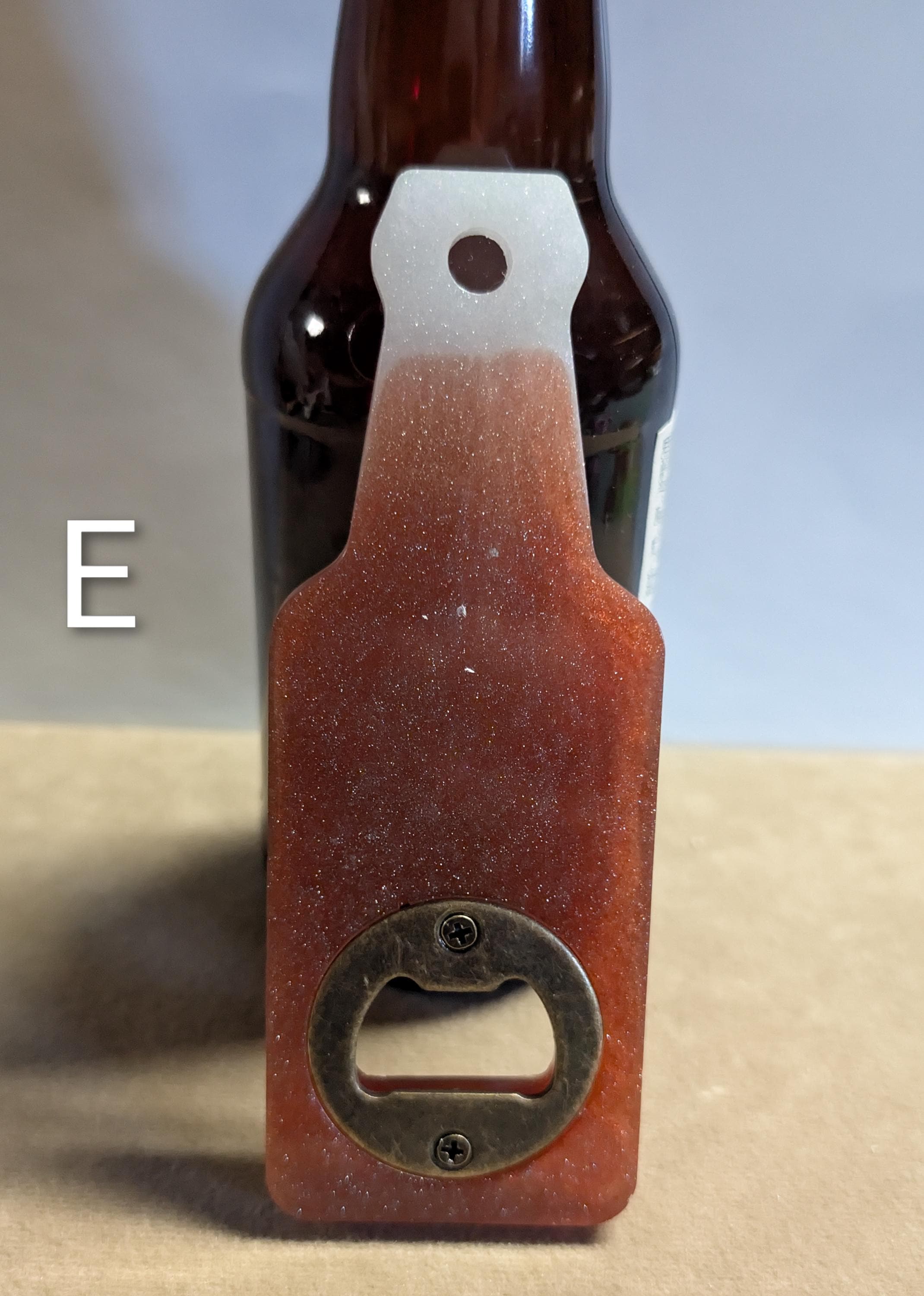 Bottle shaped bottle opener.  Many color options available with a magnet option on the back for hanging.