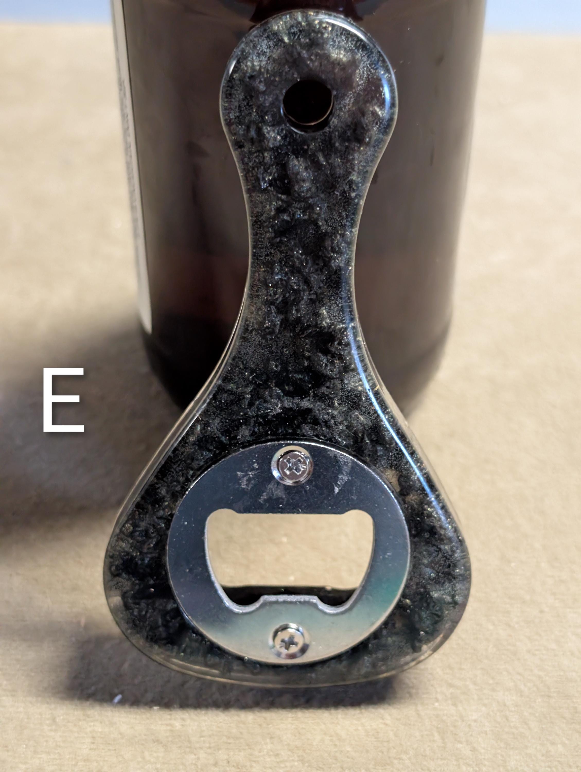 Paddle shaped bottle opener. Orange in color. Many other colors also available