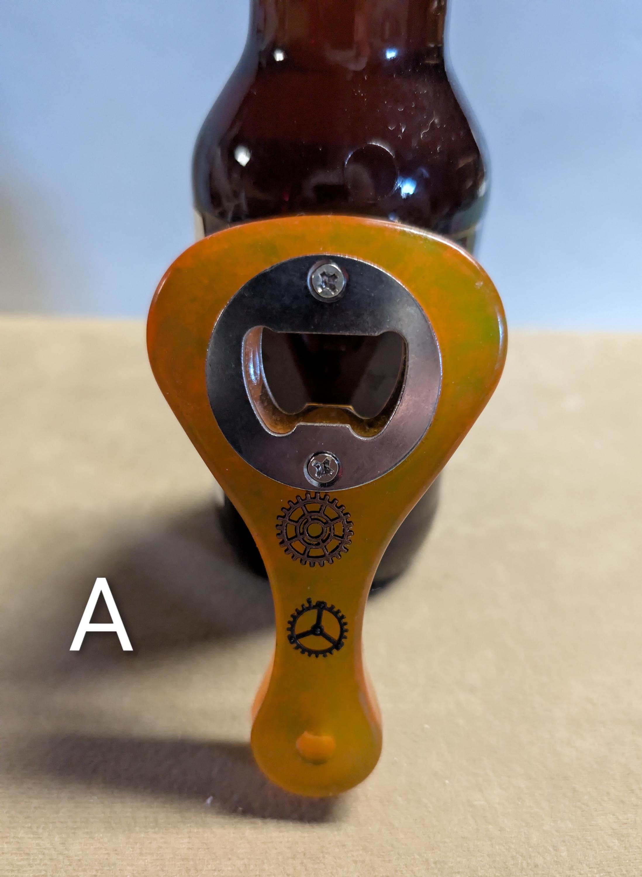Paddle shaped bottle opener. Orange in color. Many other colors also available