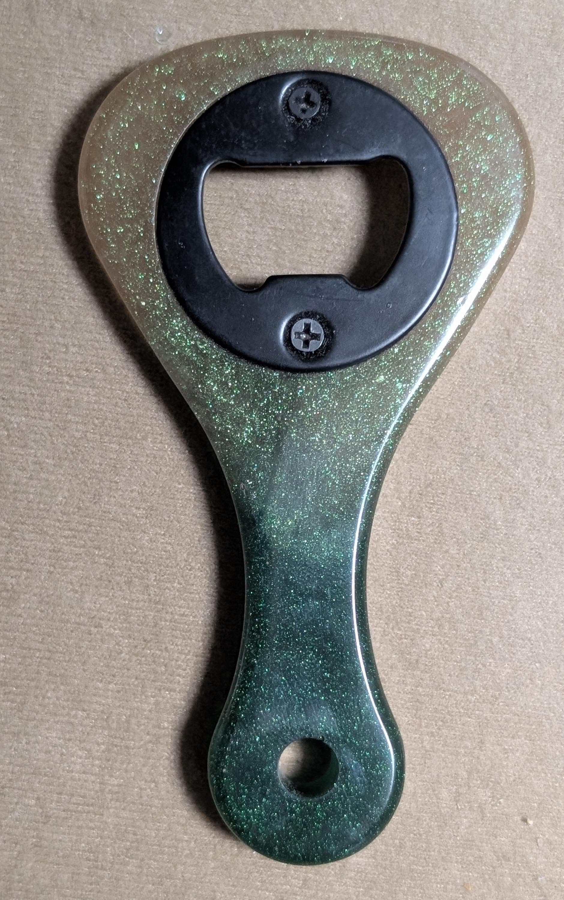 Paddle shaped bottle opener. Orange in color. Many other colors also available