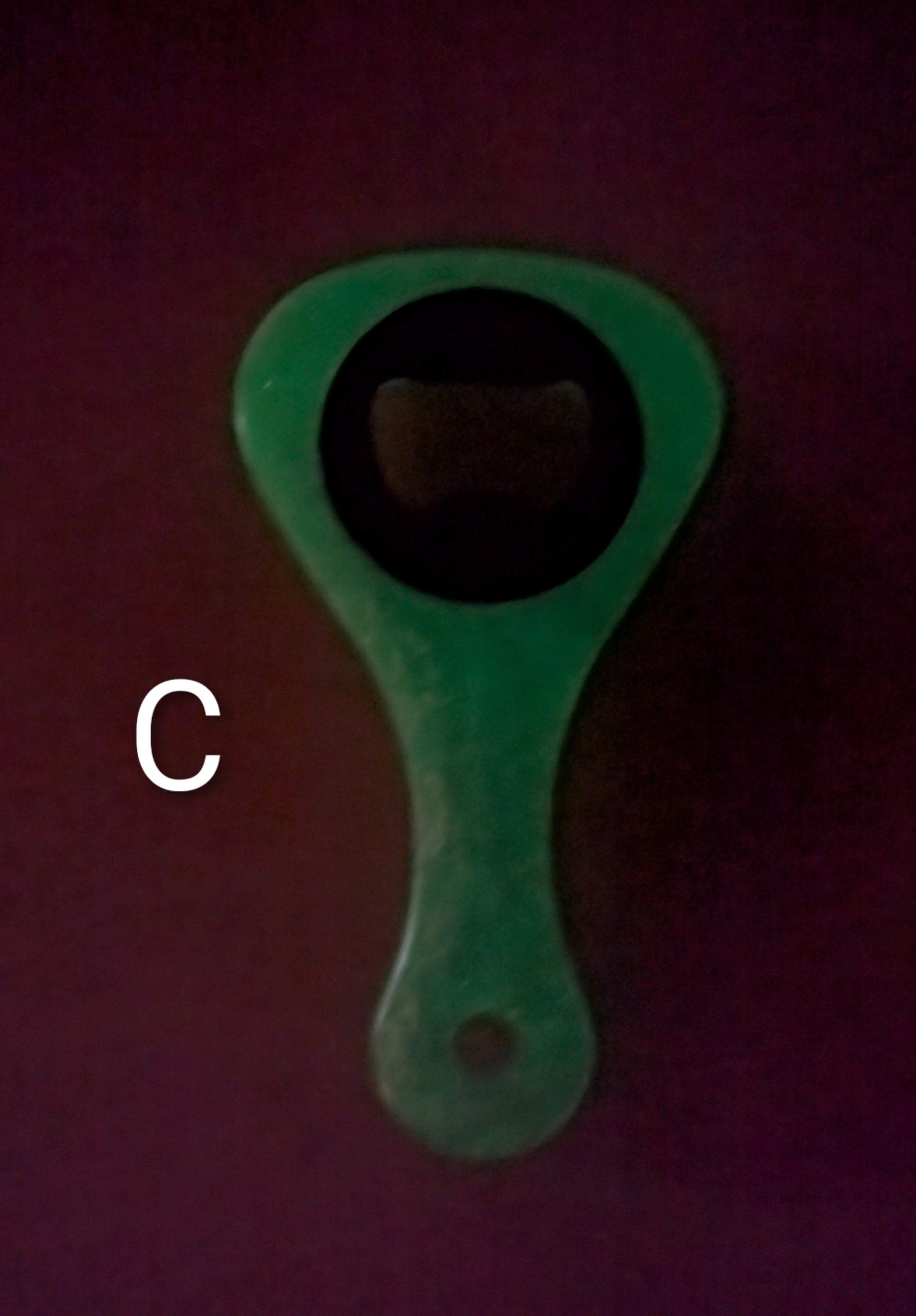 Paddle shaped bottle opener. Orange in color. Many other colors also available